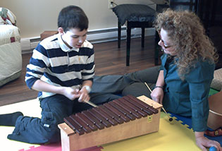 Brenda working with a child and a zylophone