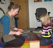 Brenda and Child playing Xylophone